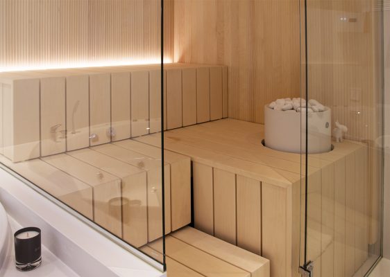 A high-power LED strip on the bench surface illuminates the entire sauna.