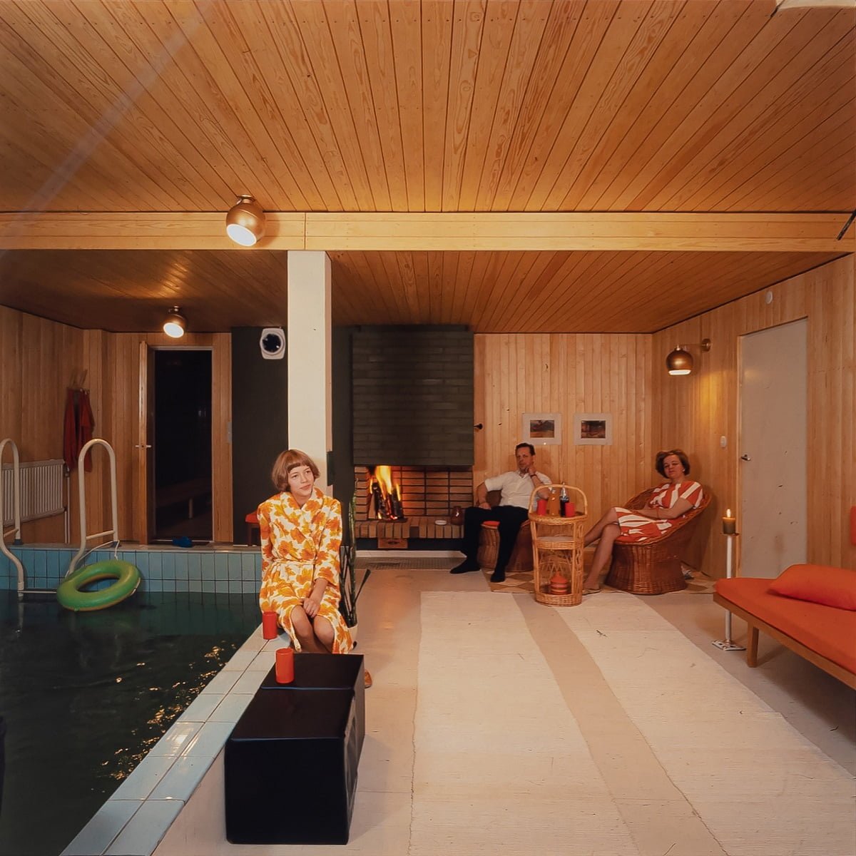 The picture shows a family enjoying their leisure time in the newly renovated, stunning pool and fireplace space. Photo from a customer's family album.