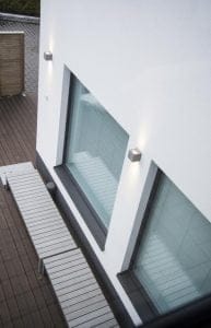Outdoor lighting can be achieved with popular wall lights, which take additional reflection from the white surface.