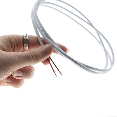 Primo piano di una mano che tiene in mano un filo LED bianco con un'estremità sbucciata, perfetto per installazioni di illuminazione personalizzate e soluzioni ad alta efficienza energetica.