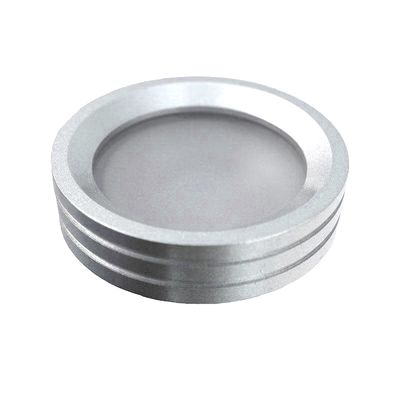 Apparecchio LED rotondo di colore argento con bordi nervati, vista obliqua, sfondo bianco. Ideale per soluzioni di illuminazione moderne e per valorizzare l'arredamento degli ambienti.