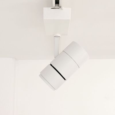 Una moderna lampada a binario bianca illumina un soffitto bianco e valorizza gli interni della vostra casa. Illuminazione LED ad alta efficienza energetica per un design elegante e contemporaneo.