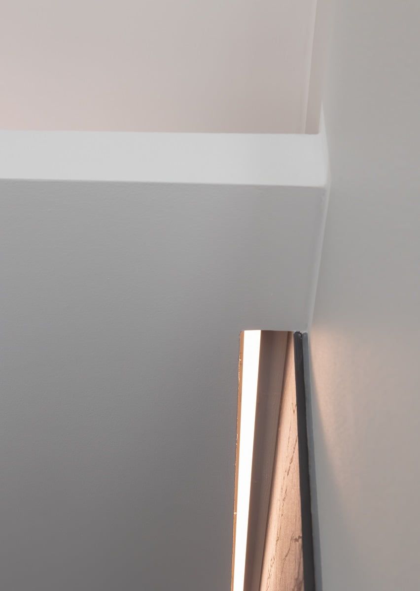 L'illuminazione indiretta è stata creata installando una striscia LED in un profilo di alluminio nella scanalatura del soffitto e sul ripiano superiore del mobile. © LedStore