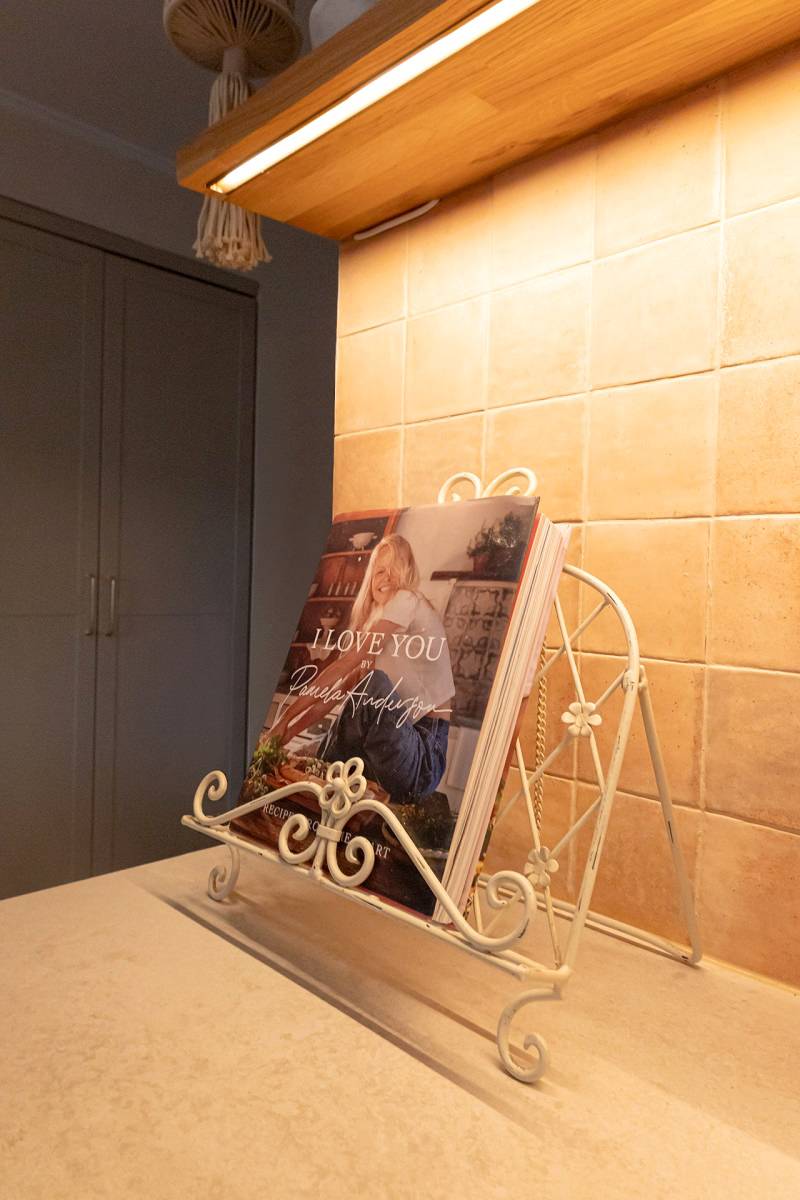 Una striscia LED installata sotto uno scaffale illumina il piano della cucina.
