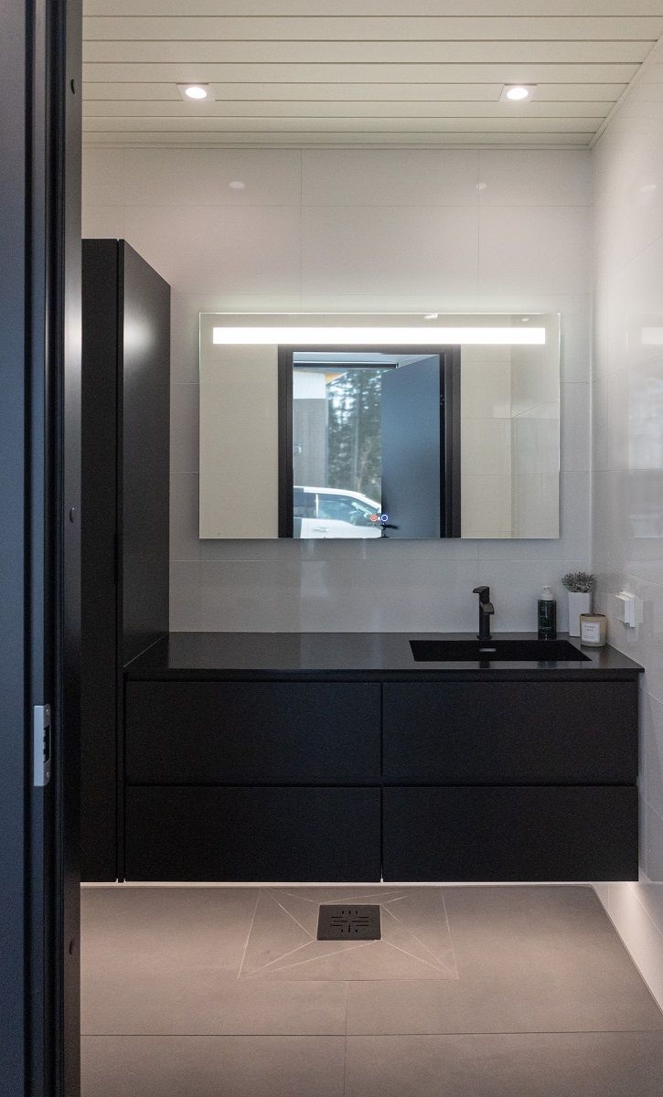 Bagno con striscia LED sotto i mobili per la luce indiretta, lampada a specchio SEELIA e due downlight LED SQ023 a soffitto.