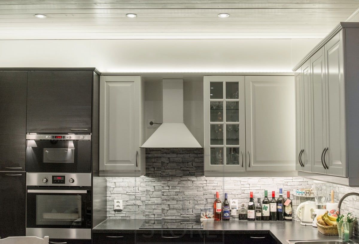 In cucina, sopra gli armadietti, le strisce a led illuminano indirettamente verso l'alto, la luce si apre attraverso il soffitto. Faretti come illuminazione generale. Il piano è illuminato da una striscia a led fissata alla base dei mobili superiori. Ledstore.fi