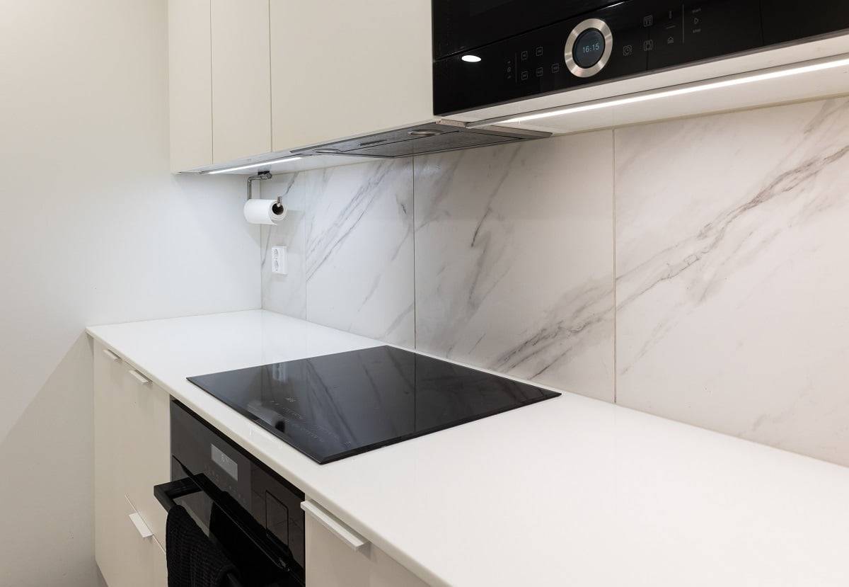 Illuminazione del piano di lavoro con profilo a strisce LED montato sul fondo dei mobili della cucina