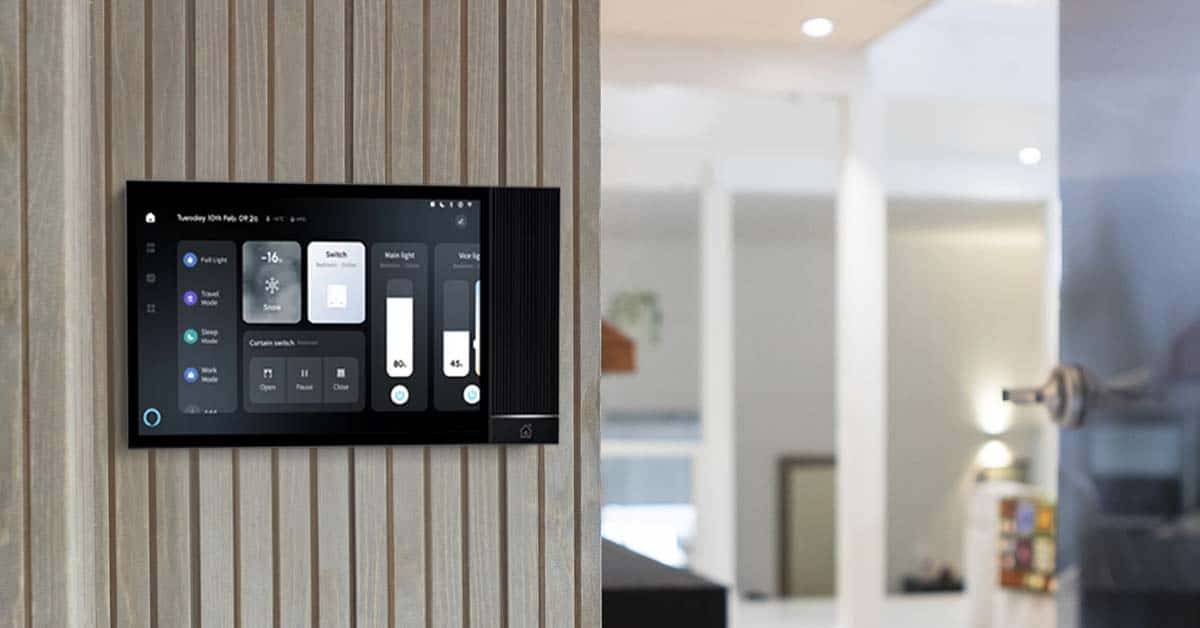 Sulla parete beige di una casa moderna c'è un pannello di controllo intelligente di LedStore.fi per controllare l'illuminazione a LED e l'home theatre.