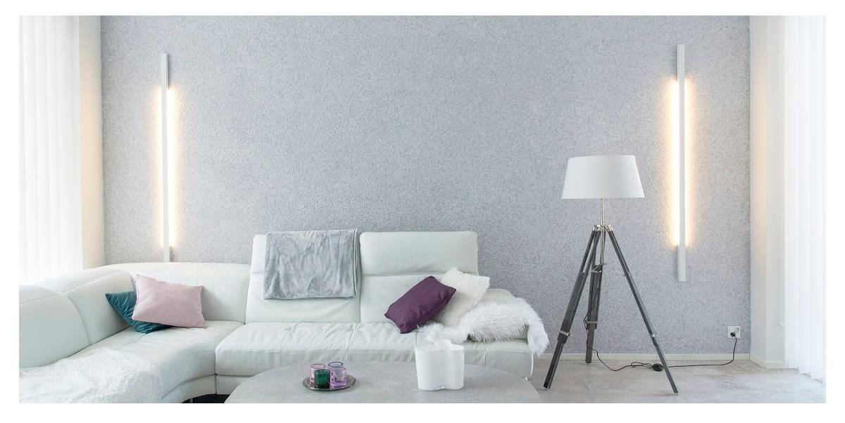 Il design dell'illuminazione di un soggiorno è importante, nell'immagine un soggiorno armonioso con luci a parete sulla parete posteriore