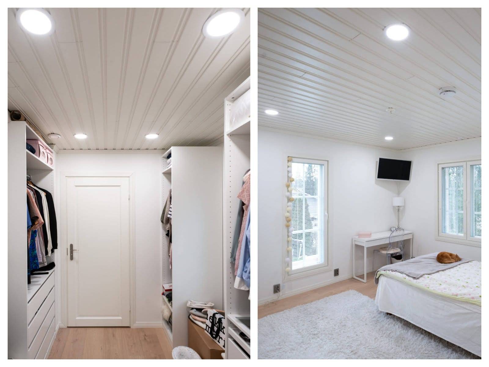 Armadio con scaffali illuminati a LED, pavimento in legno; accogliente camera da letto con piumone bianco, TV a parete, soffice tappeto. Le luci LED a soffitto illuminano entrambi gli spazi.